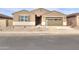 Charming single-story home featuring a two-car garage, desert landscaping, and neutral-toned exterior at 36834 W La Paz St, Maricopa, AZ 85138