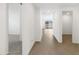 Clean hallway with light tile flooring and white walls at 36834 W La Paz St, Maricopa, AZ 85138