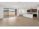 Bright and airy living room with sliding glass doors, modern light fixtures, and an open concept layout at 36834 W La Paz St, Maricopa, AZ 85138