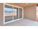 Covered patio with concrete flooring and a sliding glass door leading to the home's interior at 36834 W La Paz St, Maricopa, AZ 85138