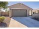 New construction home with a two-car garage and a large driveway at 3923 E Archer Dr, San Tan Valley, AZ 85140