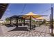 Community outdoor grill area with shade structures, tables, and seating under blue skies at 3923 E Archer Dr, San Tan Valley, AZ 85140