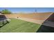 Fenced backyard with artificial grass and desert landscaping at 3948 W Salter Dr, Glendale, AZ 85308