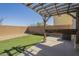 Backyard featuring an outdoor pergola with cafe lights and artificial turf at 3948 W Salter Dr, Glendale, AZ 85308