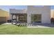 View of the backyard with a pergola, turf, and a glass slider at 3948 W Salter Dr, Glendale, AZ 85308