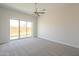 Bright bedroom featuring a ceiling fan and sliding glass doors to covered patio at 3948 W Salter Dr, Glendale, AZ 85308
