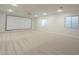 Spacious bonus room with a large projector screen, ceiling fan, and carpeted floors at 3948 W Salter Dr, Glendale, AZ 85308