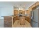 Modern kitchen featuring wooden cabinetry, stone counter, and stainless steel appliances at 3948 W Salter Dr, Glendale, AZ 85308