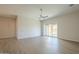 Bright living room features sliding glass doors to covered patio and modern flooring at 3948 W Salter Dr, Glendale, AZ 85308