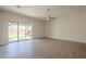 Bright living room features sliding glass doors to covered patio and modern flooring at 3948 W Salter Dr, Glendale, AZ 85308