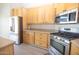 Close-up of kitchen with stainless steel appliances, granite countertops and light wood cabinetry at 8031 N 108Th Dr, Peoria, AZ 85345