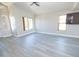 Bright living room featuring gray floors, fan and lots of windows at 8031 N 108Th Dr, Peoria, AZ 85345