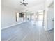 Airy living room features gray floors, a ceiling fan, an open floorplan and a fireplace at 8031 N 108Th Dr, Peoria, AZ 85345