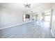 Bright open living room featuring gray wood floors, ceiling fan, and open concept design at 8031 N 108Th Dr, Peoria, AZ 85345