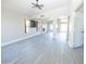 Light and airy living room boasting gray floors, a ceiling fan, and an open floorplan at 8031 N 108Th Dr, Peoria, AZ 85345