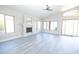 Open-concept living room highlighting gray floors, a fireplace, and a sliding glass door at 8031 N 108Th Dr, Peoria, AZ 85345