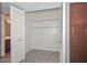 Walk-in closet features white shelving, louvred doors, and ceramic tile flooring at 8390 W Oraibi Dr, Peoria, AZ 85382