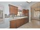 Bright kitchen featuring wood cabinets, tile backsplash and stainless steel dishwasher at 8390 W Oraibi Dr, Peoria, AZ 85382