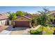 House exterior featuring a two-car garage and well-manicured lawn at 16209 W Davis Rd, Surprise, AZ 85374