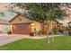 House exterior featuring a brown garage door and lush front yard at 16209 W Davis Rd, Surprise, AZ 85374