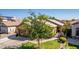 House exterior showcasing a two-car garage and lush landscaping at 16209 W Davis Rd, Surprise, AZ 85374