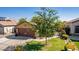 House exterior with a two-car garage and a green front yard at 16209 W Davis Rd, Surprise, AZ 85374