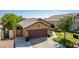 House exterior with a two-car garage and landscaped front yard at 16209 W Davis Rd, Surprise, AZ 85374