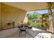 Covered patio with wrought iron table and chairs at 16209 W Davis Rd, Surprise, AZ 85374