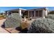 Attractive single-story home with lush desert landscaping and a charming screened-in porch at 215 N Power Rd # 361, Mesa, AZ 85205