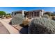 Attractive single-story home with lush desert landscaping and a charming screened-in porch at 215 N Power Rd # 361, Mesa, AZ 85205
