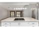Bright kitchen island with cooktop and a view to a spacious living area at 215 N Power Rd # 361, Mesa, AZ 85205
