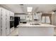 Spacious kitchen featuring white cabinetry, stainless appliances, and a large central island at 215 N Power Rd # 361, Mesa, AZ 85205