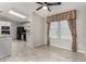 Open concept with tile flooring near white kitchen and black appliances at 215 N Power Rd # 361, Mesa, AZ 85205