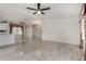 Spacious living room with tile flooring and ceiling fan fixture near kitchen at 215 N Power Rd # 361, Mesa, AZ 85205