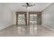Bright living room with tile flooring, ceiling fan, windows, and glass sliding doors at 215 N Power Rd # 361, Mesa, AZ 85205