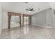 Bright living room with tile flooring, ceiling fan, and glass sliding doors at 215 N Power Rd # 361, Mesa, AZ 85205