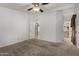 Spacious main bedroom with carpet and views to main bathroom at 215 N Power Rd # 361, Mesa, AZ 85205