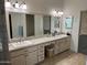 Double vanity bathroom with granite countertops and large mirror at 3824 E Kachina Dr, Phoenix, AZ 85044