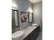 Double vanity bathroom with granite countertops and updated fixtures at 3824 E Kachina Dr, Phoenix, AZ 85044