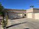 Two-car garage with ample parking space and desert landscaping at 3824 E Kachina Dr, Phoenix, AZ 85044