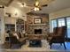 Cozy living room with a stone fireplace and hardwood floors at 3824 E Kachina Dr, Phoenix, AZ 85044