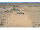 Aerial view of a house on a lot in a rural desert setting, mountains in the distance at 6300 N 419Th Ave, Tonopah, AZ 85354