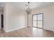 Bright dining area with sliding glass door and modern chandelier at 6300 N 419Th Ave, Tonopah, AZ 85354