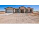 Newly constructed single-story home with a two-car garage and neutral color palette at 6300 N 419Th Ave, Tonopah, AZ 85354