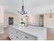 View of kitchen island with white cabinets and quartz countertop at 6300 N 419Th Ave, Tonopah, AZ 85354