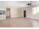 Open living room with tile floors, high ceilings, and a view to the kitchen at 6300 N 419Th Ave, Tonopah, AZ 85354