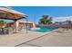 Community pool with patio furniture and shade umbrella at 7550 N 12Th St # 143, Phoenix, AZ 85020