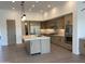 Spacious kitchen featuring modern cabinetry, stainless steel appliances, and a center island with marble countertop at 10336 E Chia Way, Scottsdale, AZ 85262