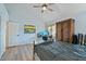 Bedroom with vaulted ceiling, wood flooring, and backyard access at 2235 E Lakecrest Dr, Gilbert, AZ 85234