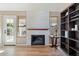 Cozy Gathering room with fireplace, built-in shelving, and hardwood floors at 2235 E Lakecrest Dr, Gilbert, AZ 85234